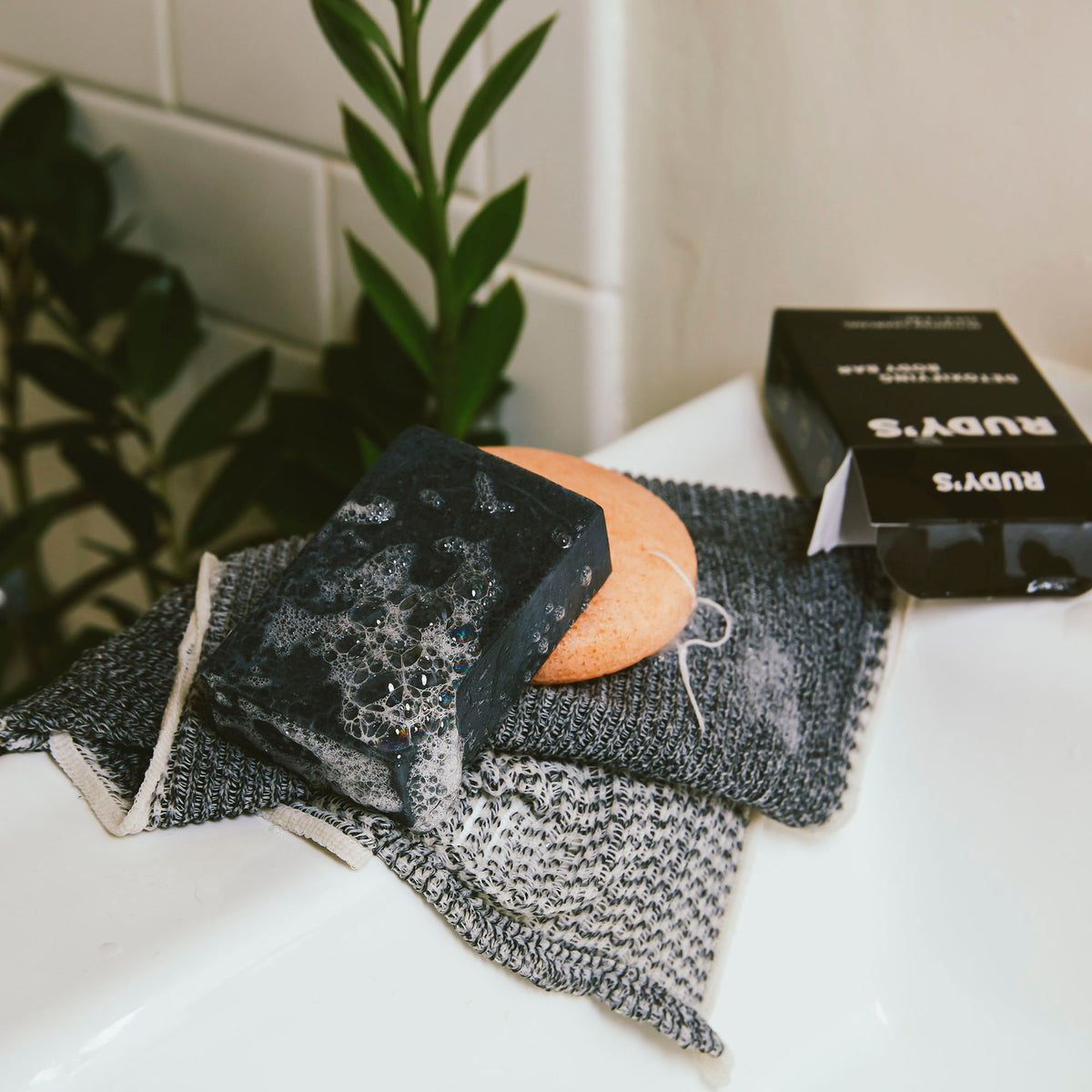 A soapy bar of Rudy's Detoxifying Body Bar with Activated Charcoal